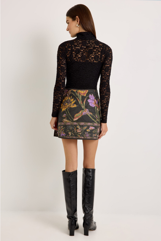 Orca Reversible Skirt in Nightshade featuring a quilted floral print, asymmetrical wrap front, and mini silhouette.