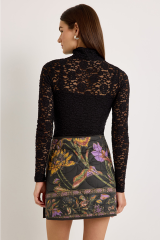 Orca Reversible Skirt in Nightshade featuring a quilted floral print, asymmetrical wrap front, and mini silhouette.