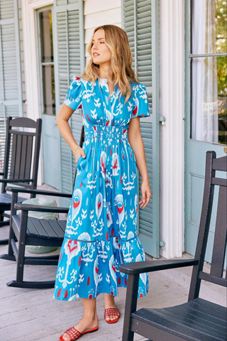Sheridan French Eloise Dress in Americana Ikat featuring cobalt blue ikat print, ruched waist, flutter sleeves, midi silhouette, and side pockets