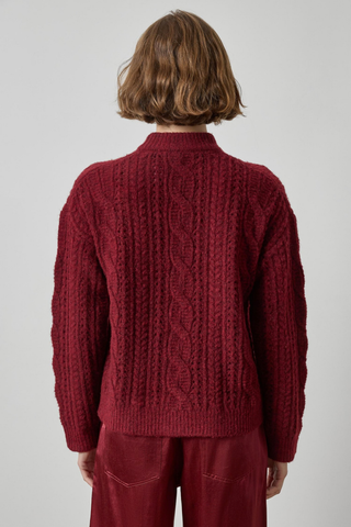 Woman wearing the Lilla P Relaxed Cable Knit Sweater in Port, a burgundy cable-knit crewneck sweater.