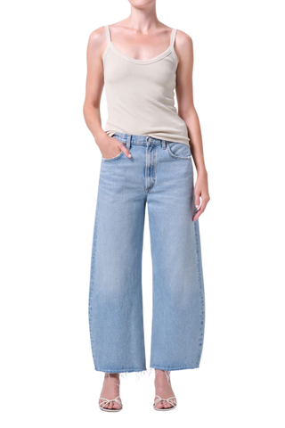 AGOLDE Low Curve Fray Jean in Force featuring a low-rise fit with a curved leg and raw frayed hem in a light wash