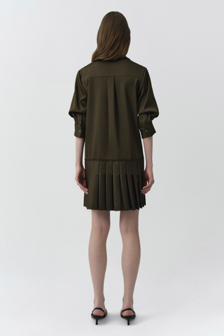 SIMKHAI Regina Mini Dress in dark olive featuring a pointed collar, short puff sleeves, concealed button front, and pleated mini hem.