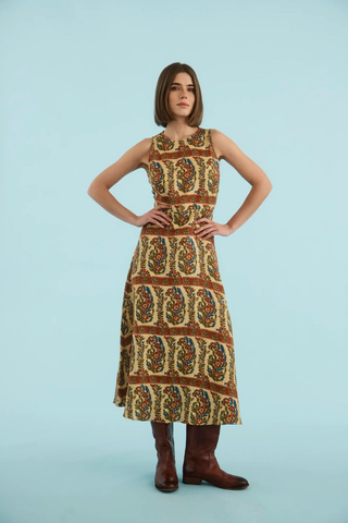 Sleeveless printed linen maxi dress with fitted bodice and full skirt.