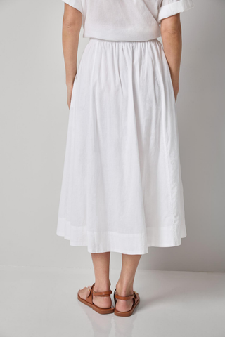 Model wearing the Lilla P Voile Circle Skirt in White featuring a midi length, elastic waistband, lightweight cotton voile fabric, and relaxed A-line silhouette paired with brown leather sandals