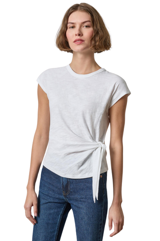 A woman modeling a light gray heathered short-sleeve t-shirt with a side tie detail, paired with blue jeans, against a plain white background.