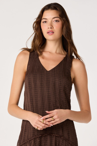 ASTR Halo Dress in Brown Plaid featuring a V-neckline, drop waist, and flowing asymmetric maxi hem.