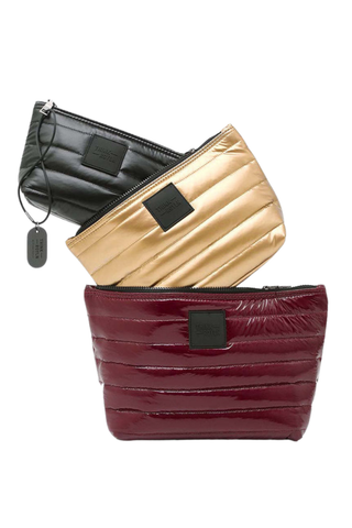 Think Royln Travel Trio set of three quilted pouches in burgundy, pearl, and black.