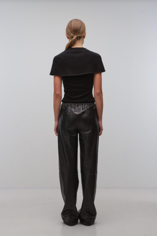 Black cape-style top with a modern tailored silhouette.
