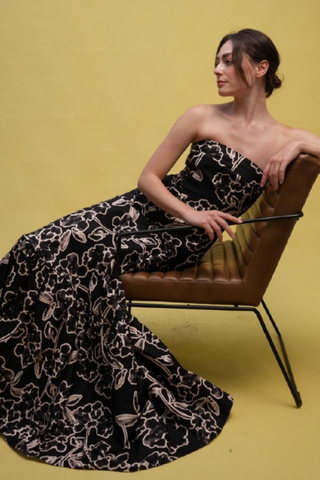 Strapless black printed formal gown with a structured bodice and full skirt.