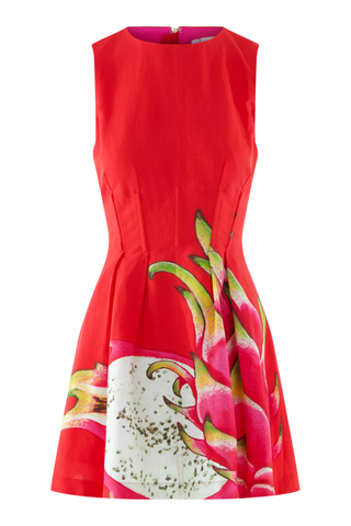Model wearing the Emily McCarthy Vivi Dress in Dragon Fruit featuring a bright red colorway, sleeveless silhouette, flared skirt, and oversized dragon fruit print detail