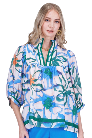Woman wearing a colorful floral blouse on a white background