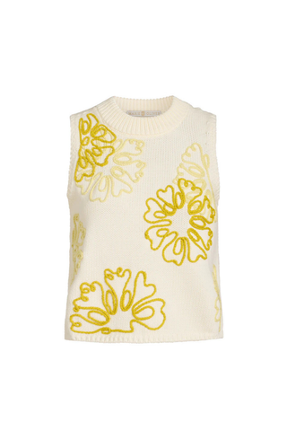 Model wearing the Marie Oliver Natasha Top in Lumino, a cream sleeveless knit sweater featuring oversized yellow floral embroidery, ribbed trim, a crew neckline, and a relaxed cropped fit.