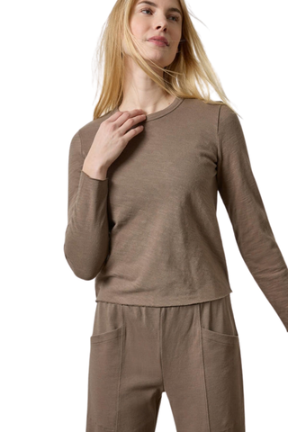 Woman wearing the Lilla P Vintage Bias Tee in Shiitake, a fitted taupe long-sleeve cotton tee.