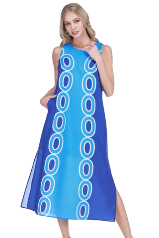 Woman wearing a blue dress with white circular patterns on a white background
