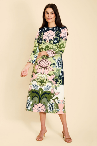 Mestiza Consuela Midi Dress in Eventide Gardens featuring a colorful botanical floral print, long sleeves, and a tailored midi silhouette.