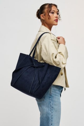 Urban Expressions Soren Tote in Midnight blue vegan suede with long shoulder straps, bow-front detail, and matching zip pouch.