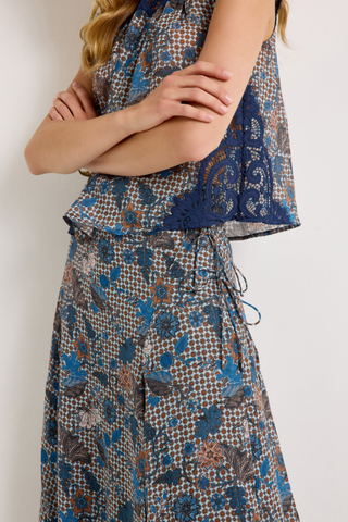 Gracen Skirt in Aegean featuring a blue and brown printed maxi silhouette with lace panel detailing and a flowing hem.