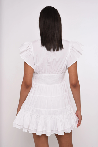 Love the Label Madelyn Mini Dress in bright white featuring flutter sleeves, lace inset details, a tie waist, and tiered ruffle hem