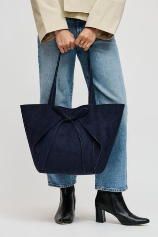 Urban Expressions Soren Tote in Midnight blue vegan suede with long shoulder straps, bow-front detail, and matching zip pouch.