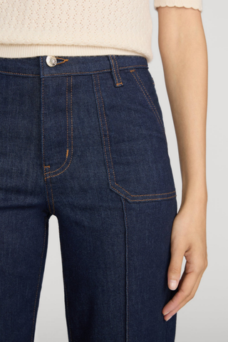 FRAME Le Slim Palazzo Pintuck Pocket jeans in dark Rinse wash with a high-rise waist, front patch pockets, pintuck seams, and wide-leg silhouette.