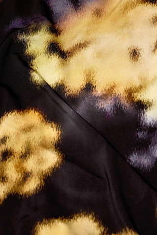 Marie Oliver Eloise Top in Lush featuring a black and yellow abstract floral print, fitted long sleeves, and sleek turtleneck silhouette.