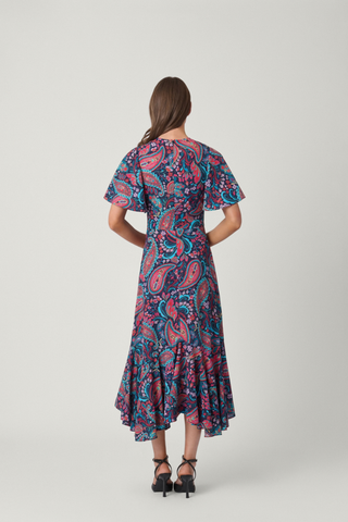 Shoshanna Mallie Dress in Multi featuring a vibrant paisley print, flutter sleeves, fitted bodice, and flowing asymmetrical hem.