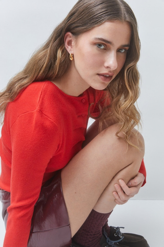Suncoo Gemoni Sweater in Rose featuring a bright rose hue, long sleeves, button front, and dimensional ruffle detailing.