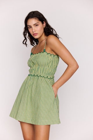 Green striped mini dress with smocked bodice and scalloped neckline detail