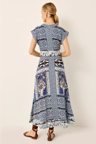 Woman wearing a blue patterned dress on a white background
