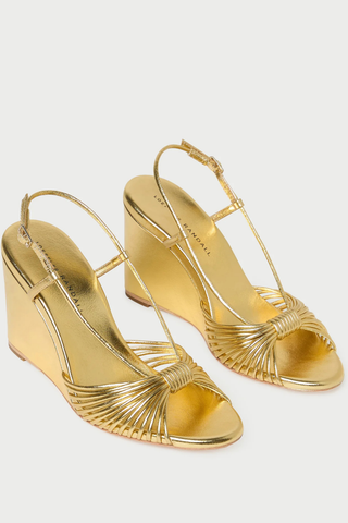 Loeffler Randall Marren Wedge in gold metallic leather featuring knotted mignon toe straps, slingback strap, open toe, and 3.5-inch wedge heel