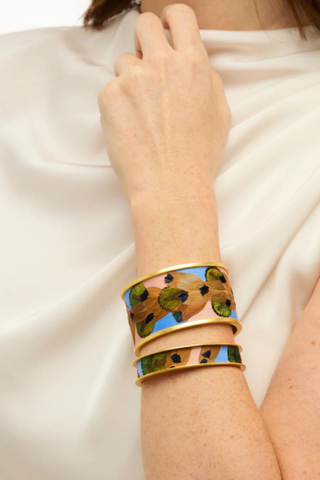 Brackish Shannon Wide Cuff bracelet with handcrafted feather detailing in champagne, sky blue, gold, and green tones with matte gold finish