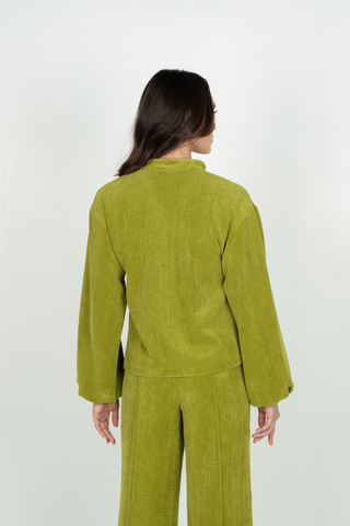 Emily McCarthy Lolli Top in Cardamom green featuring an open neckline, long voluminous sleeves, gathered cuffs, and relaxed fit.