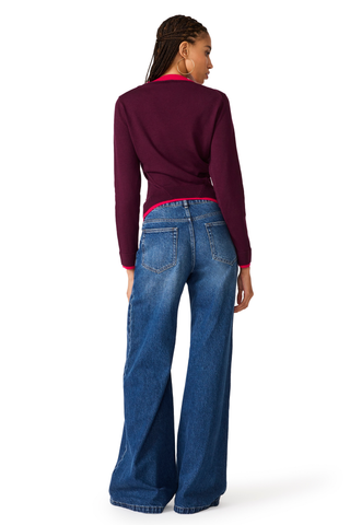Deep fig fitted cardigan with contrast pink trim and button-front closure.
