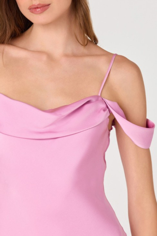 Woman wearing a pink off-the-shoulder midi dress with draped neckline and flowy skirt from ASTR on a white background.