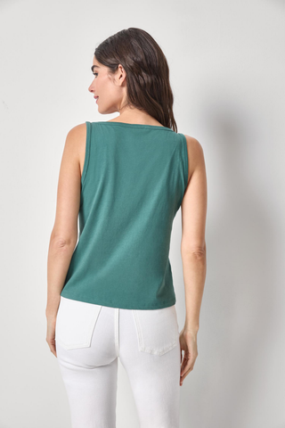 Model wearing the Lilla P Organic V-Neck Tank in Everglade featuring soft organic cotton, a flattering v-neckline, sleeveless silhouette, and relaxed everyday fit paired with white denim
