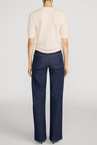 FRAME Le Slim Palazzo Pintuck Pocket jeans in dark Rinse wash with a high-rise waist, front patch pockets, pintuck seams, and wide-leg silhouette.