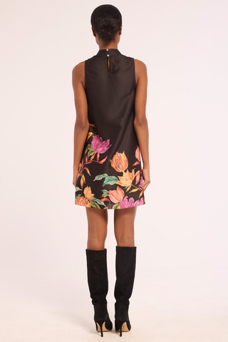 Misa Andie Dress in Flora Border featuring black satin, a gathered high neckline, sleeveless shift silhouette, and colorful floral print along the mini hem.