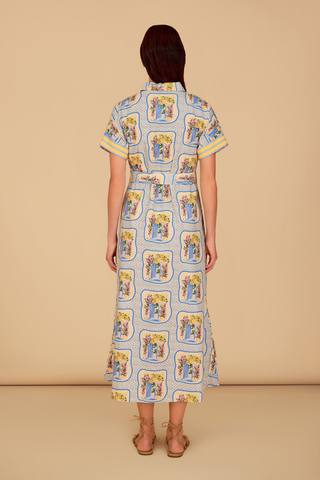 Blue and yellow printed midi dress with button front, short sleeves, and tie waist styled with flat sandals