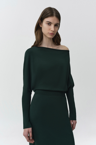 SIMKHAI Janese Off Shoulder Midi Dress in deep Everglade green with long sleeves, a fitted waist, and straight midi skirt.