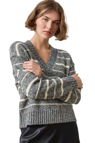 Woman wearing the Lilla P Multi Stripe V-Neck Sweater in Shadow Stripe, a relaxed grey and white striped knit sweater.