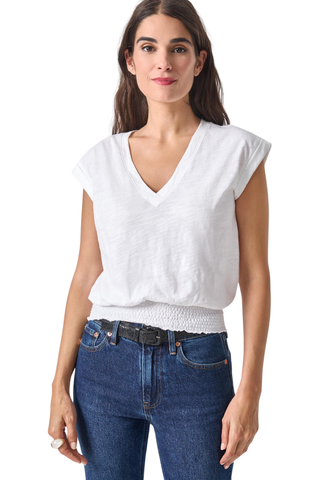 Lilla P white v-neck tee with cap sleeves and smocked hem worn with denim