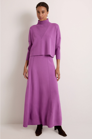 Claudie Popover in Iris featuring a cropped purple knit silhouette, mock neckline, and three-quarter batwing sleeves.