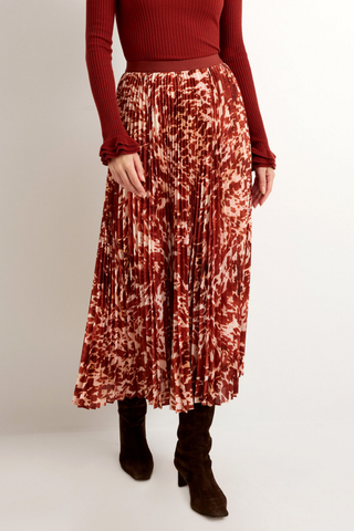 Wesley Skirt in Calico featuring a red and ivory printed pleated maxi silhouette with a contrasting auburn waistband.