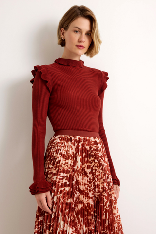 Wesley Skirt in Calico featuring a red and ivory printed pleated maxi silhouette with a contrasting auburn waistband.