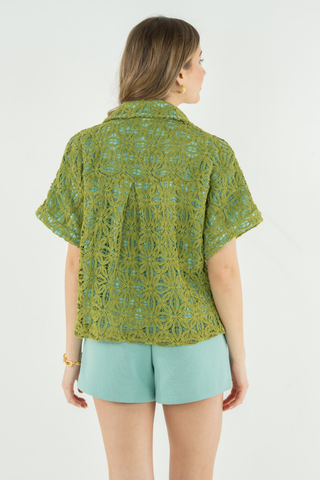 Model wearing the Emily McCarthy Luna Top in Olive Hour featuring olive lace overlay, aqua lining, button-front closure, short sleeves, and a relaxed resort-inspired silhouette
