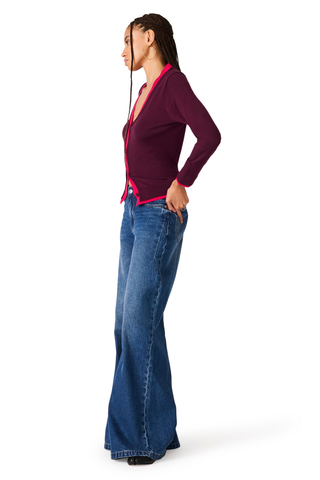 Deep fig fitted cardigan with contrast pink trim and button-front closure.