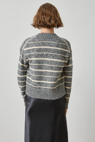 Woman wearing the Lilla P Multi Stripe V-Neck Sweater in Shadow Stripe, a relaxed grey and white striped knit sweater.