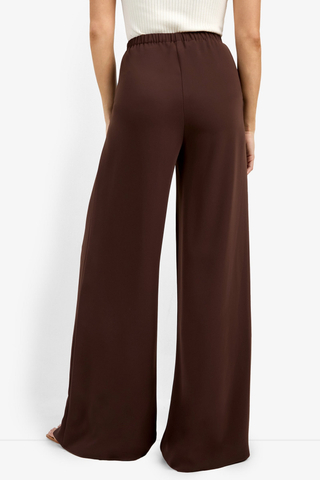Brown wide-leg pants worn by a person on a white background