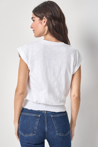 Lilla P white v-neck tee with cap sleeves and smocked hem worn with denim