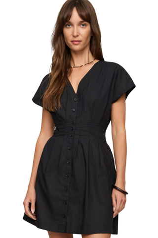 Model wearing the Z Supply Sanna Mini Dress in Black featuring a V-neckline, smocked waist, and short sleeves.